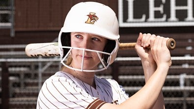 Lehigh University’s Josie Charles bats in softball game hours after wide-awake hand surgery.